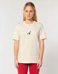 A woman wearing a City to Ocean T-shirt with 'City to Ocean' logo design on the front. 100% Cotton in natural raw white, untreated sustainable fabric on plain background