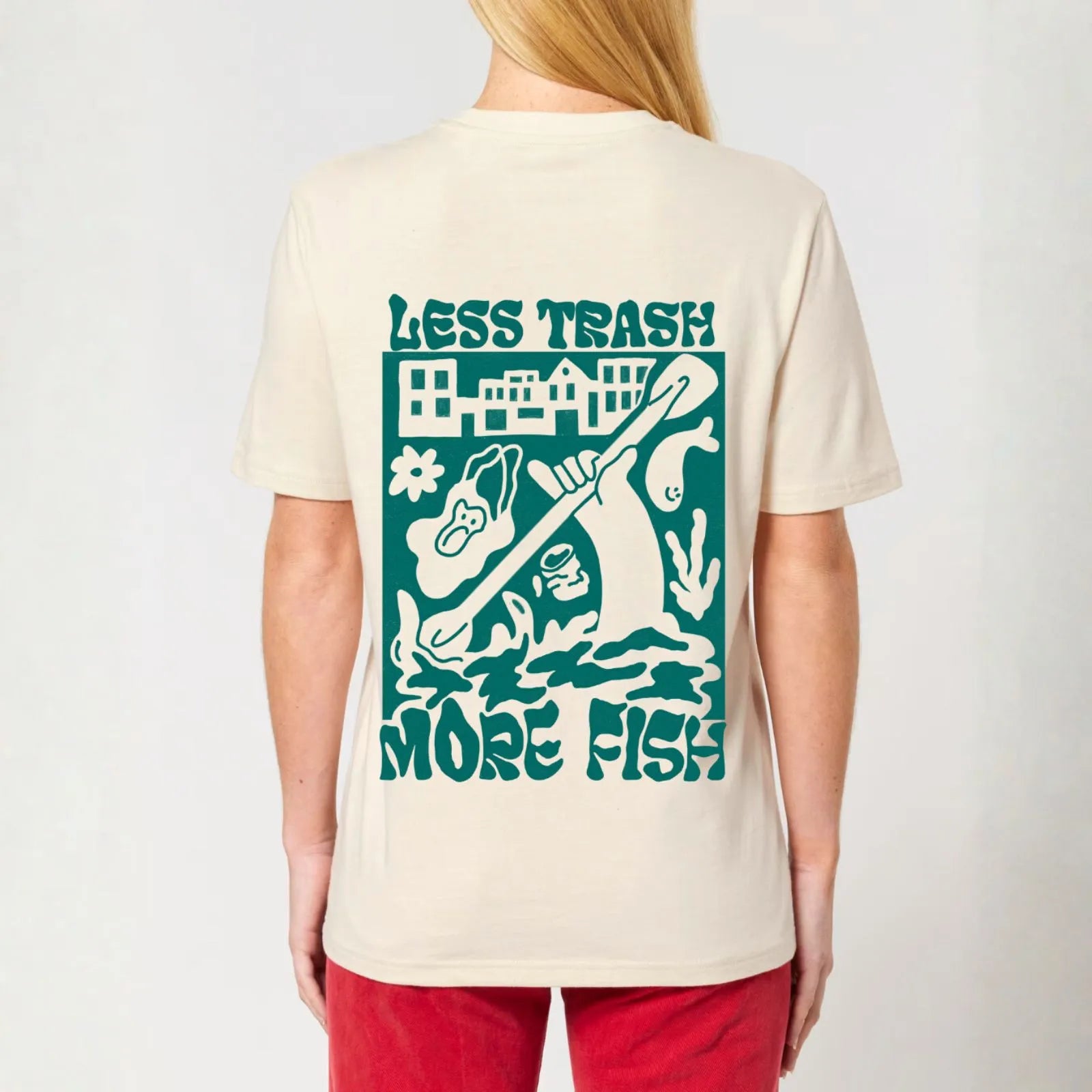 A woman wearing a City to Ocean T-shirt with 'Less Trash More Fish' graphic design on the back. 100% Cotton in natural raw white, untreated sustainable fabric