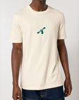 Natural raw white cotton t-shirt with a green City to Ocean logo worn by a man on a white background