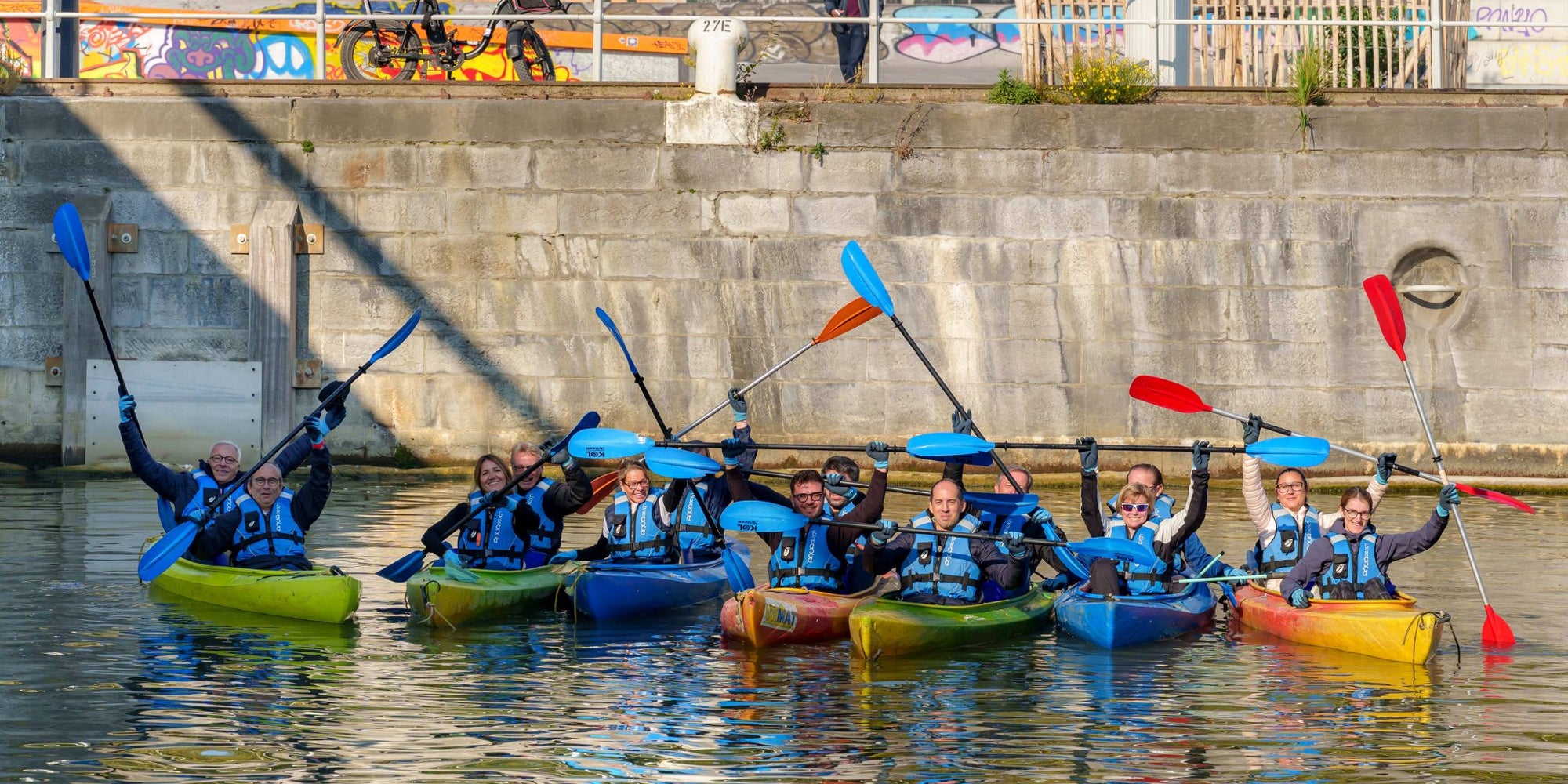 City to Ocean volunteers in kayaks with paddles on a river