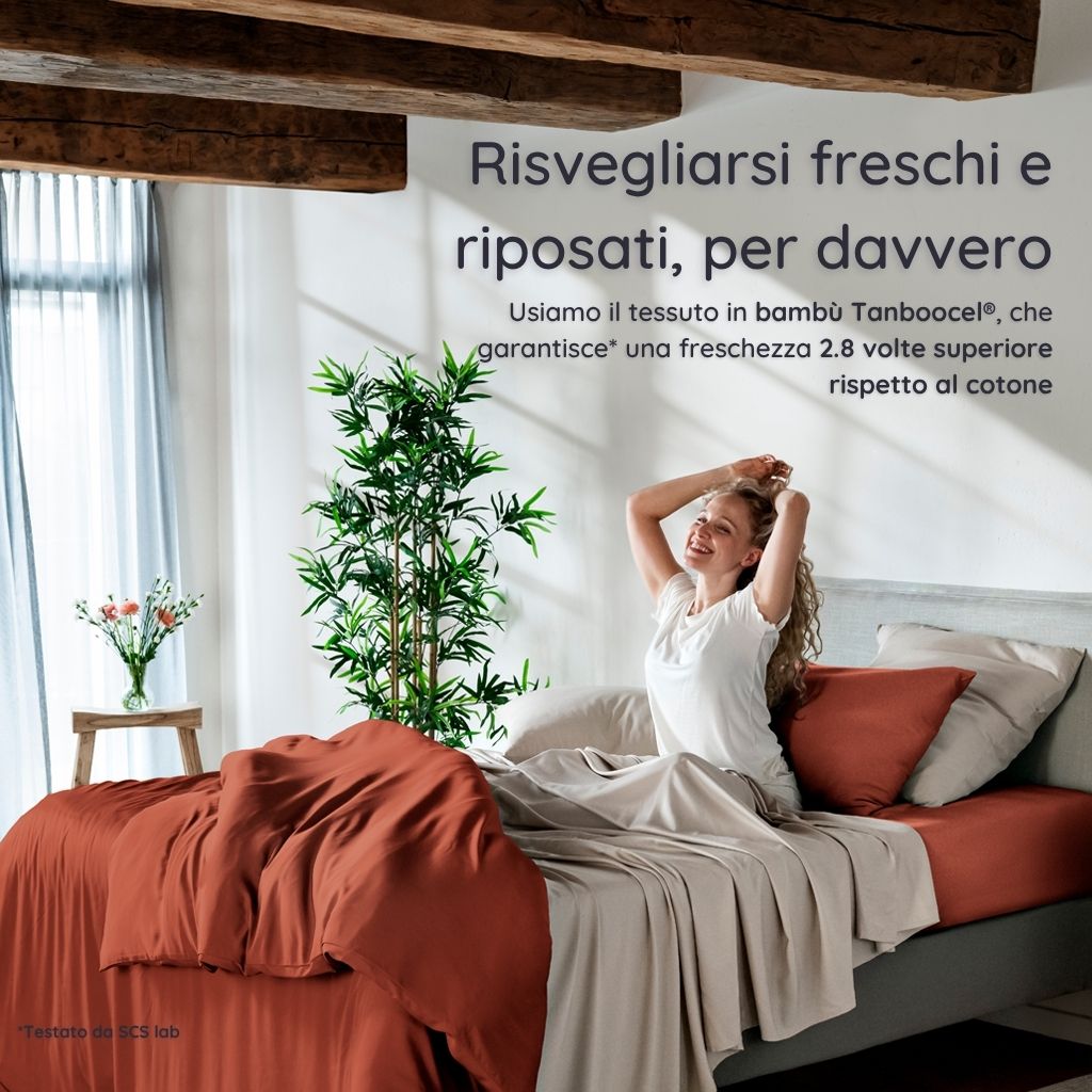 Woman waking up in a bright bedroom in a bed with bambaw cozy bamboo bedsheets in terraccota and sand colours with natural light and plants.